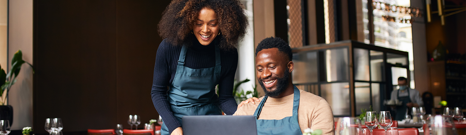 man and women working on computer at business
