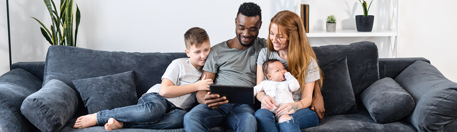 family sitting on couch watching movie