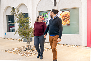 man and woman walking holding hands