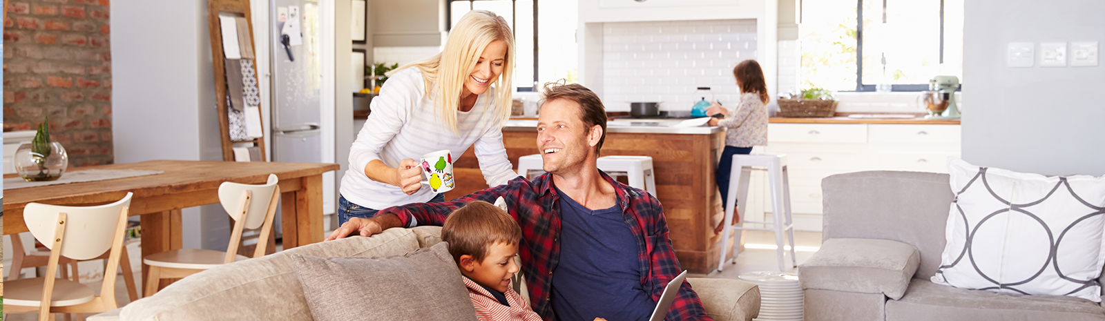 family of 4 in living room of their home smiling