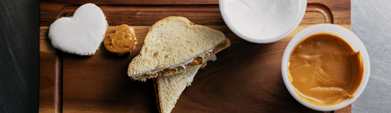 Peanut butter and marshmallow fluff sandwhich on cutting board